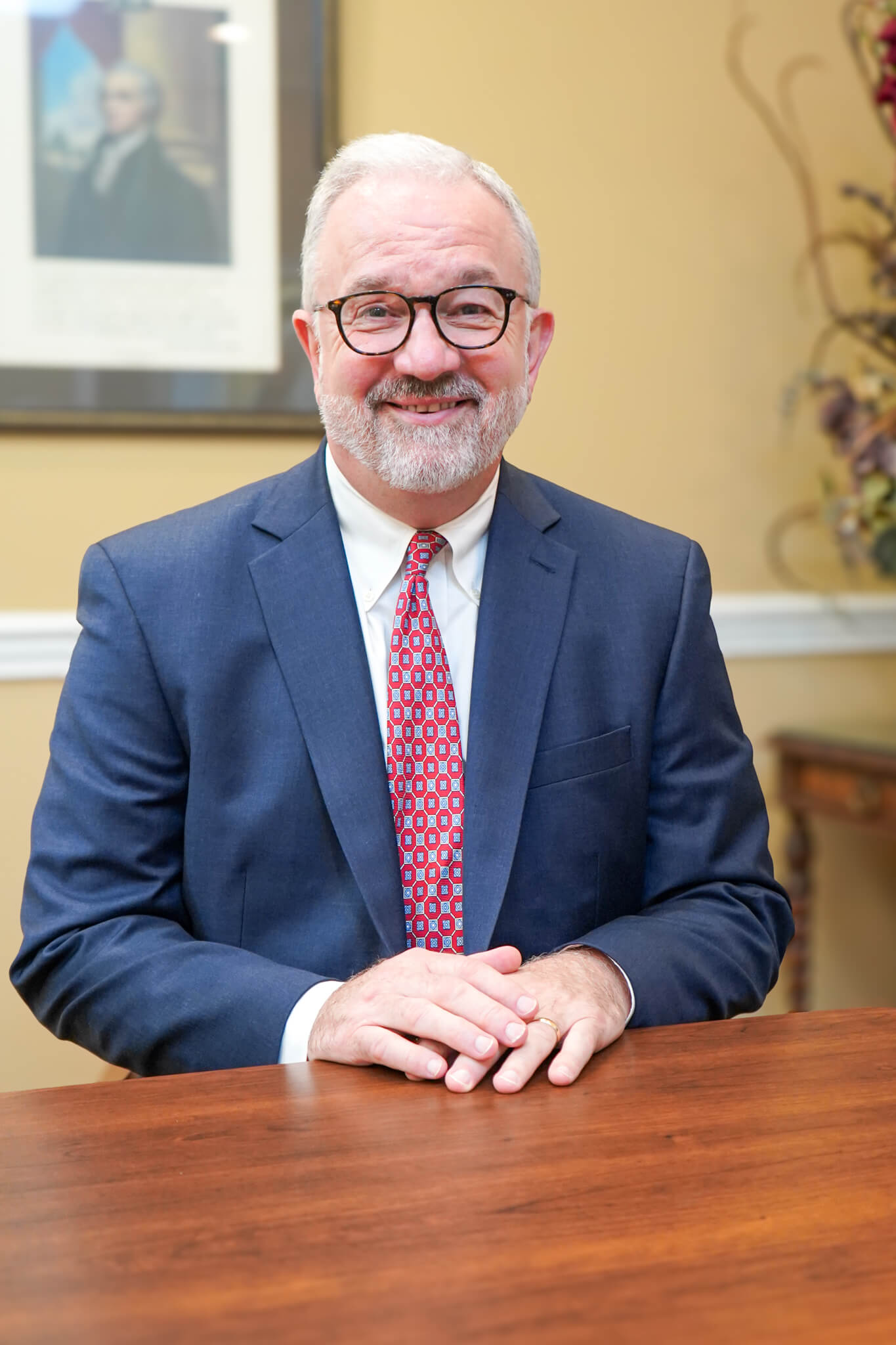 Personal injury attorney and founding member of CCJS, Kenny Cole poses for a photo smiling at a conference table at their office in Huntsville, Alabama.