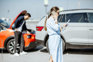 Woman is contacting her insurance after being in a car crash.
